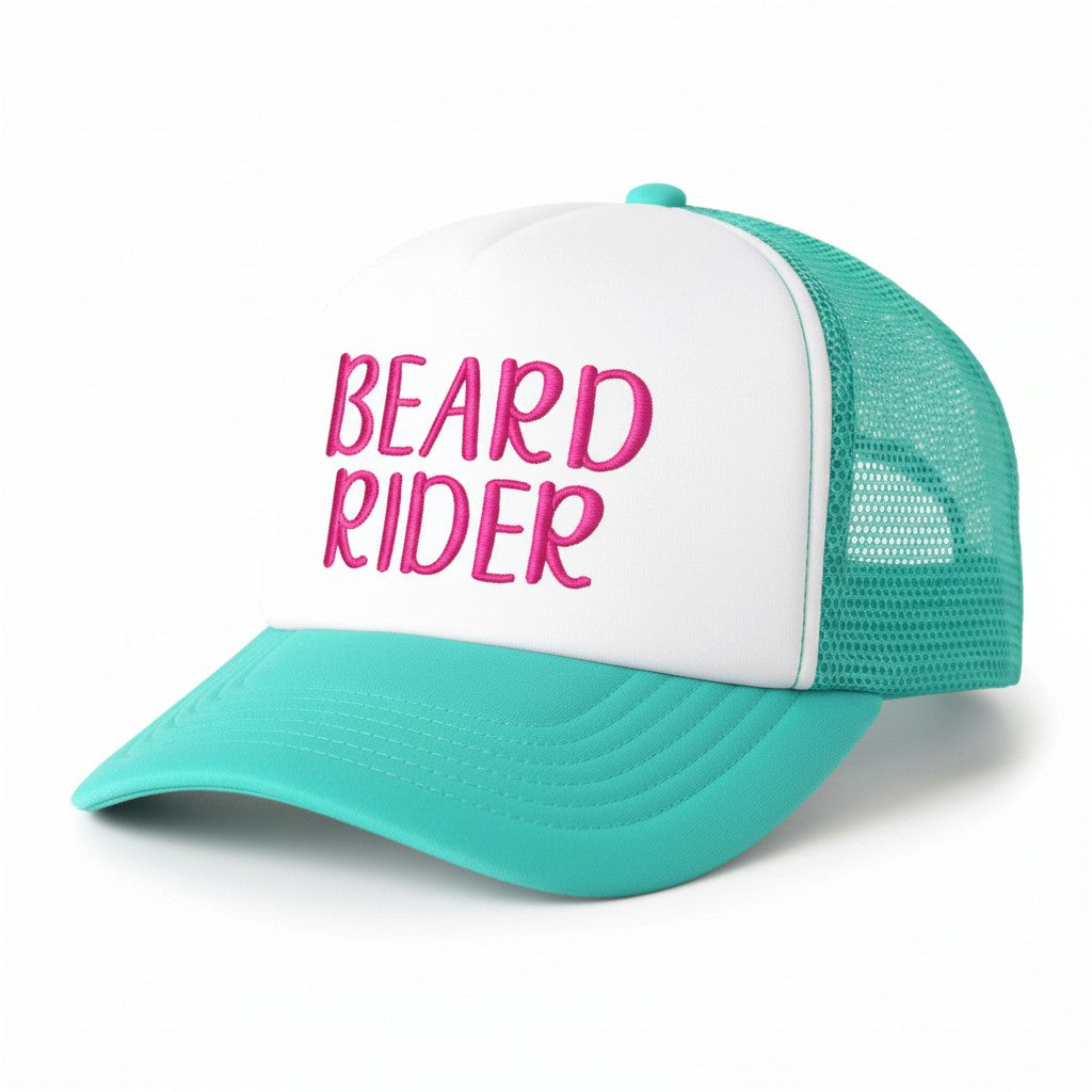 Dirty Merch Apparel Beard Rider trucker hat with white foam front, teal mesh back, and pink embroidered text.