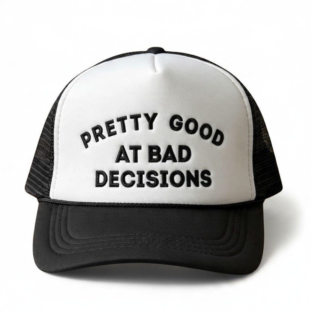 Dirty Merch Apparel black and white trucker hat with Pretty Good at Bad Decisions embroidered text on the front