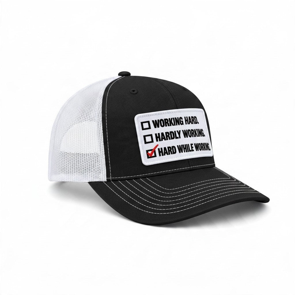 Dirty Merch Apparel black and white trucker hat featuring an embroidered Hard While Working checklist patch