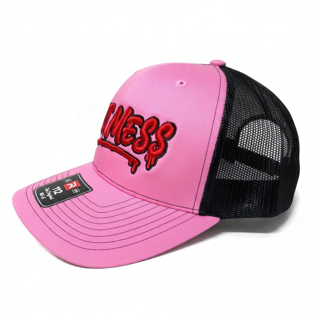 Dirty Merch Apparel pink and black trucker hat with red graffiti-style Hot Mess embroidery and mesh back panels.