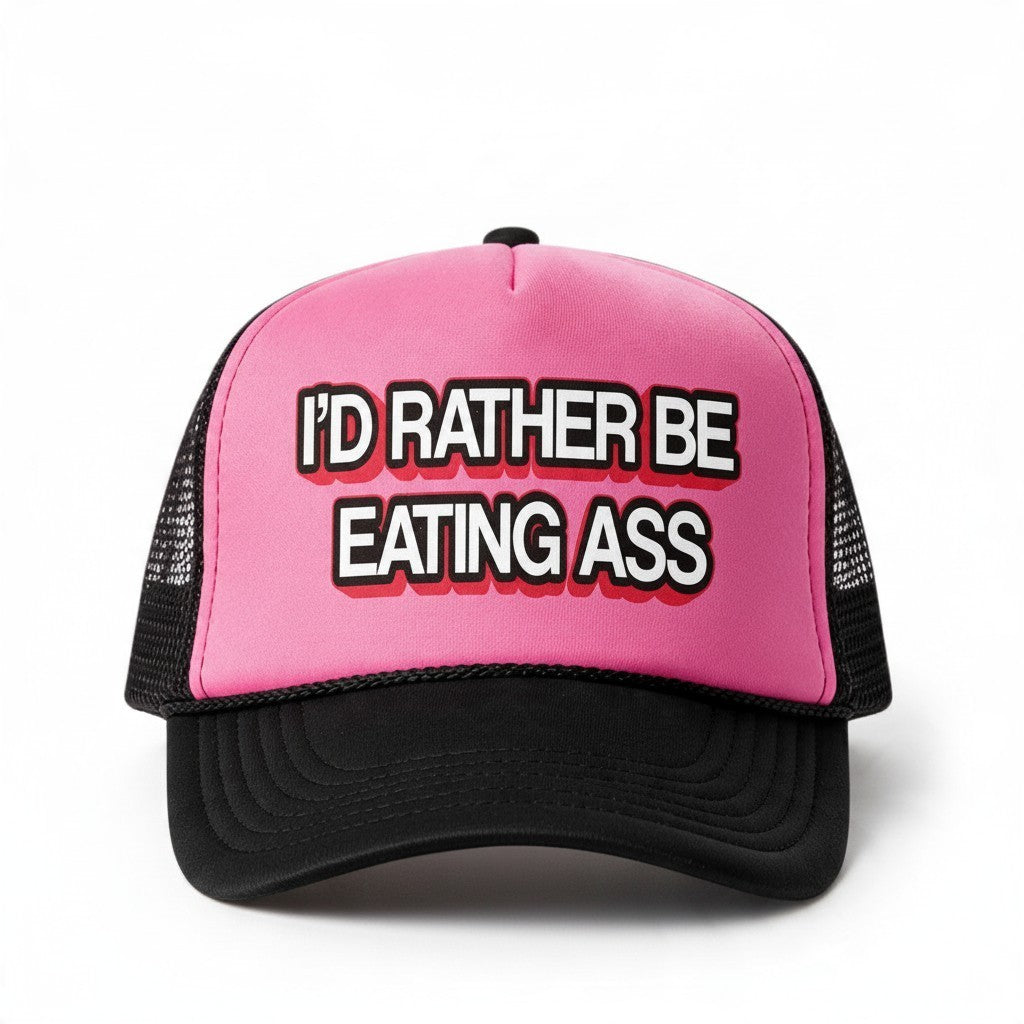 Dirty Merch Apparel pink and black Richardson 112 trucker hat with embroidered I’d Rather Be Eating Ass text
