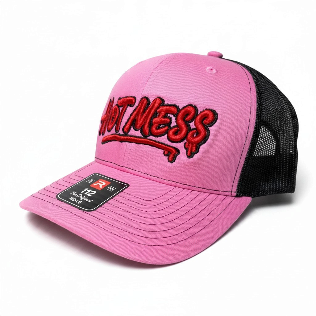 Dirty Merch Apparel pink and black trucker hat with red graffiti-style Hot Mess embroidery and mesh back panels.